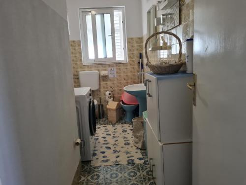 a small bathroom with a toilet and a refrigerator at Villa Agata in Lastovo