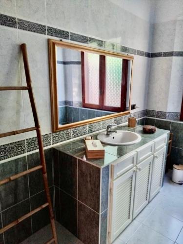 a bathroom with a sink and a mirror at Villa Rosette Ile du levant in Hyères