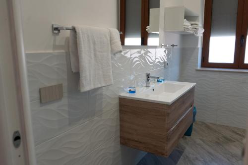 a bathroom with a white sink and a mirror at La dolce vita in Agerola