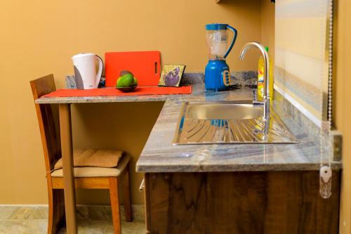 a kitchen with a sink and a counter with a counter top at Cozy haven in Kampala