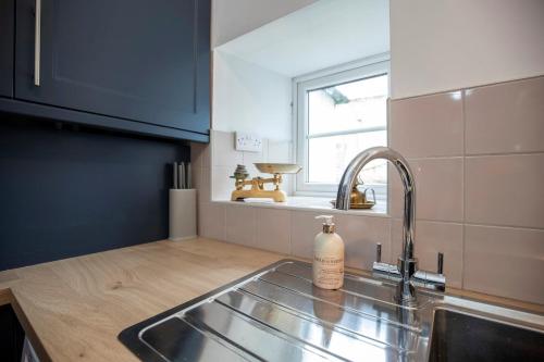 a kitchen with a sink and a window at 2 Bedroom Cottage By Cozy Quarters Property Management Holiday Lets Wolsingham Near River Waskerley in Wolsingham