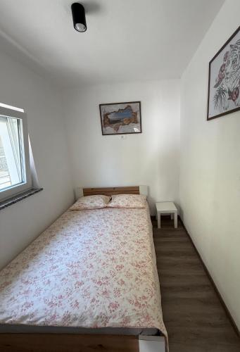 a small bedroom with a bed in the corner at Apartment Zart 1 in Dekani