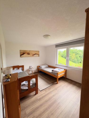a room with two beds and a window at Vikendica Brda in Banja Luka