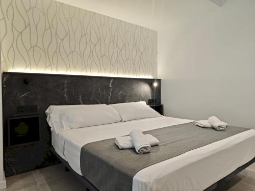 a bedroom with a large bed with towels on it at AH Rentals in Vinarós