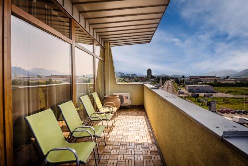 a balcony with chairs and a view of a city at Apartments Sofia - Luxury Penthouse in Liptovský Mikuláš