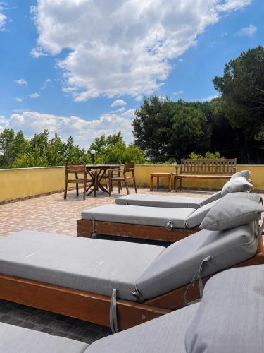 a group of four mattresses sitting on a patio at Hotel Garden Albania in Golem