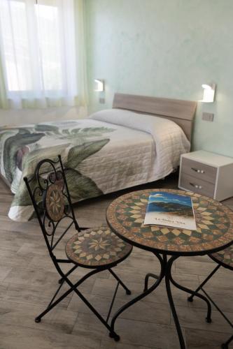a bedroom with a bed and a table with a book on it at La dolce vita in Agerola