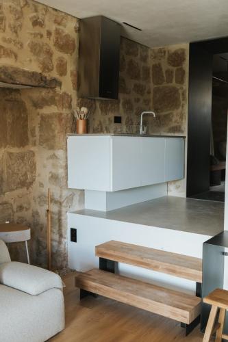 a kitchen with a white counter and a table at Los ojos del Alai in Labastida