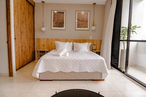 a bedroom with a bed with two towels on it at Cerritos Premium Tower & Mall in Pereira