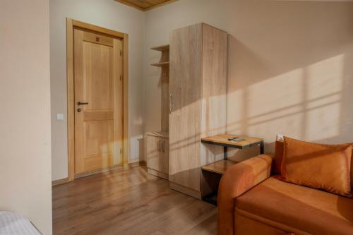 a living room with a couch and a table at Hotel Babuda in Mestia in Mestia