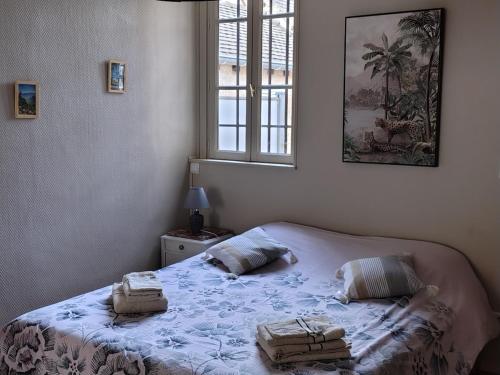 a bedroom with a bed with two baskets on it at Studio chez Jef in Nuits-Saint-Georges