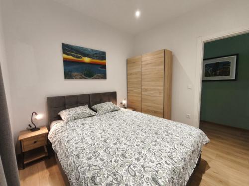 a bedroom with a bed and a dresser at Olive Tree Apartment in Kaštela