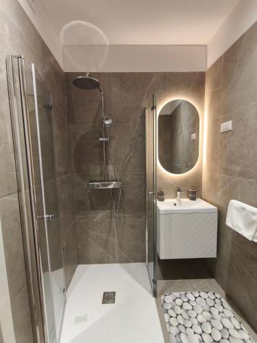 a bathroom with a shower and a sink at Olive Tree Apartment in Kaštela
