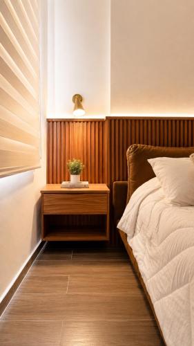 a bedroom with a bed and a table with a plant on it at Bogart 206 in Guadalajara