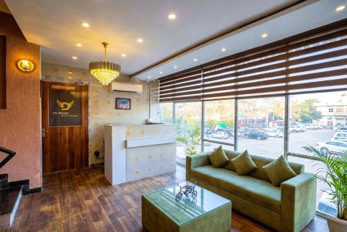 a living room with a couch and a table at Hotel Velvet Dreams Inn & Banquet in Kharar