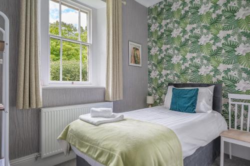 a small bedroom with a bed and a window at The Capsule Room at The Lairbeck in Keswick in Keswick