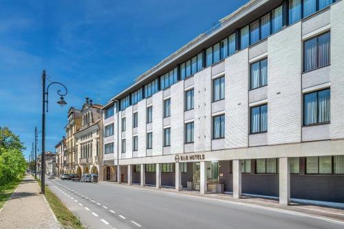 a large white building on the side of a street at B&B HOTEL Padova Methis in Padova