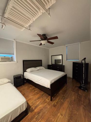 a bedroom with two beds and a ceiling fan at 8 minutes from 2026 FIFA World Cup Final! in Rutherford