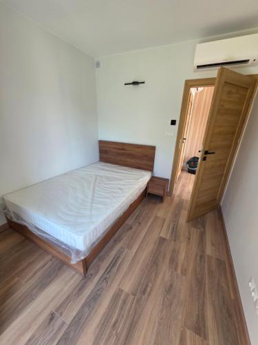 a bedroom with a bed and an open door at Widokowa Dąbrowa in Dąbrowa
