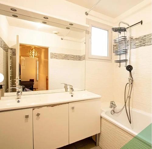 a bathroom with a sink and a tub and a shower at Villa Near Versailles in Feucherolles