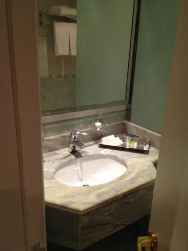a bathroom counter with a sink and a mirror at Executives Hotel - Azizia in Riyadh