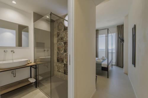 a bathroom with a sink and a mirror at Almarè Affittacamere in Favignana