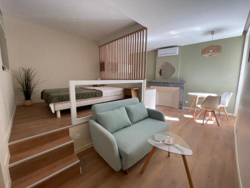 a room with a bed and a couch and a chair at Demeure BelPel - Appartement Daurel in Bessan