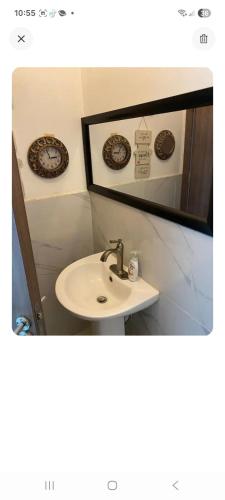 a bathroom with a sink and a mirror at New Kingston Condo Apt in Kingston