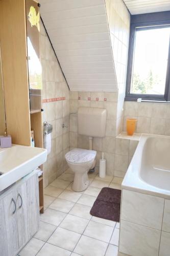 a bathroom with a toilet and a sink at GEM Stay in Oberhausen