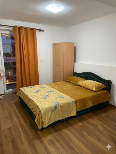 a bedroom with a bed and a wooden floor at Old Town Casa in Ulcinj