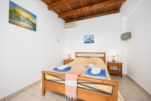 a bedroom with a bed and two night stands at Spiros Beach Villa in Frangokastello