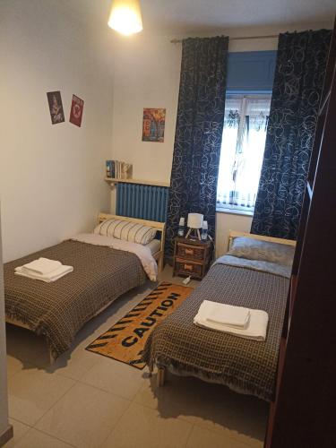 a room with three beds and a window at Ël Sautafoss in Agliè