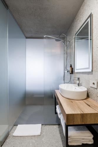 a bathroom with a sink and a glass shower at Campeador Expo in Bucharest