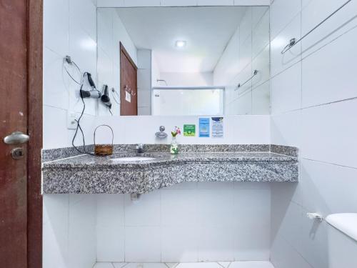 a bathroom with a sink and a mirror at EstrelaMar Boutique in Búzios
