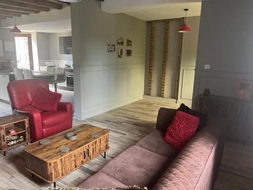 a living room with a couch and a coffee table at The Old Post Office Gite -Jouac in Jouac
