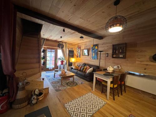 a living room with a couch and a table at le Chalet in Saint-Loup-sur-Thouet