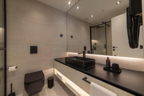a bathroom with a black sink and a mirror at Home apartments in Mostar