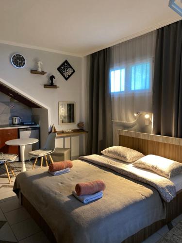 a hotel room with two beds with towels on them at FERRUM house in Hanioti