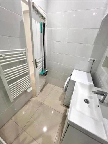 a white bathroom with a sink and a shower at Chic & Cosy in Antibes