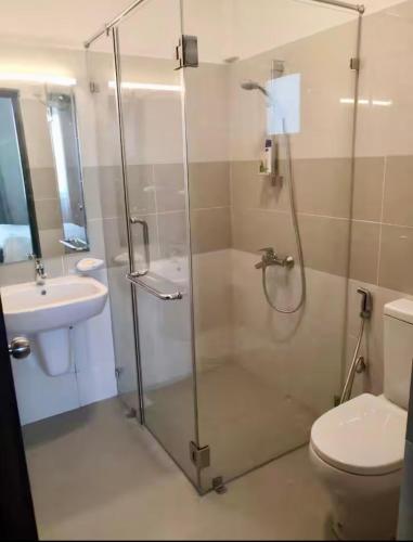 a bathroom with a shower and a toilet and a sink at apartmentleeza in Uswetakeiyawa