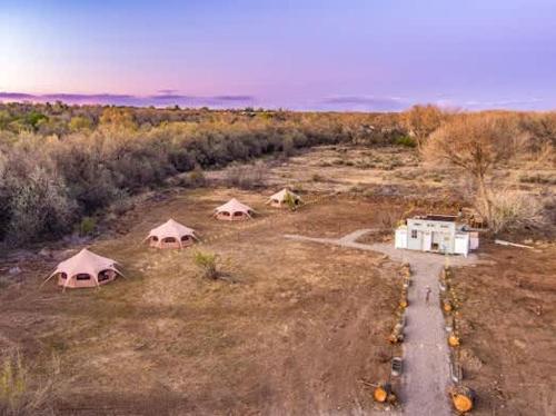 an aerial view of a field with three tents at Mesa Verde Tent in Farmington
