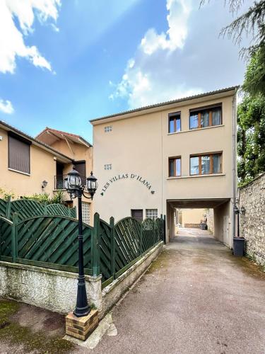 a building with a gate and a street light at Villa des Camelias in Le Pré-Saint-Gervais