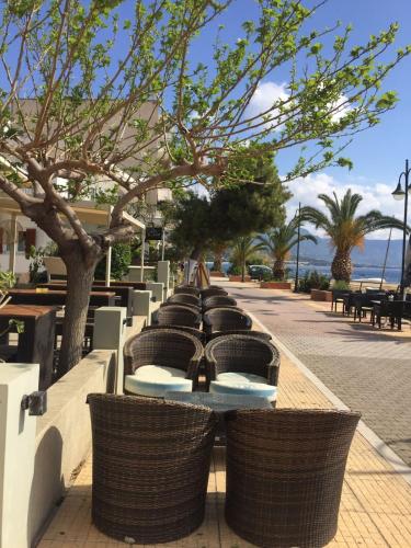 a row of tables and chairs on a street at Calma4 in Agioi Theodoroi