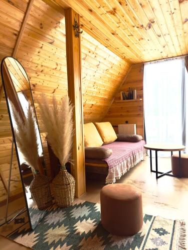 a room with a bed in a wooden cabin at Alagi Cottage Kazbegi in Kazbegi