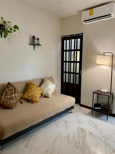 a living room with a couch with pillows on it at Loft Residencial Monterrey Norte in Monterrey