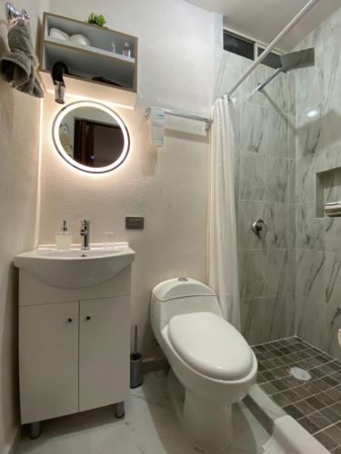 a bathroom with a toilet and a sink and a shower at Loft Residencial Monterrey Norte in Monterrey