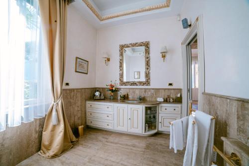 a bathroom with a sink and a mirror at Villa Castiglioni Luxury Apartment in Laglio