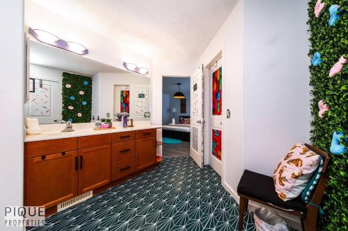 a bathroom with a sink and a mirror at The Obsolete Suite - HotTub - King Bed - AC - Pet Friendly in Edmonton