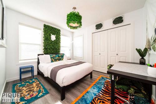 a bedroom with a bed and a table in it at The Obsolete Suite - HotTub - King Bed - AC - Pet Friendly in Edmonton