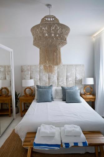 a bedroom with a large bed with a large chandelier at Beachfront Apartment - 2 Terraces - Stunning Sunrises in Gibraltar